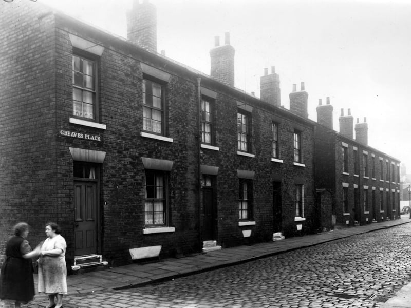Odd numbered back-to-back houses on Greaves Place, numbers run to the right in ascending order from number 1 on the left where two ladies can be seen chatting. Pictured in October 1958.