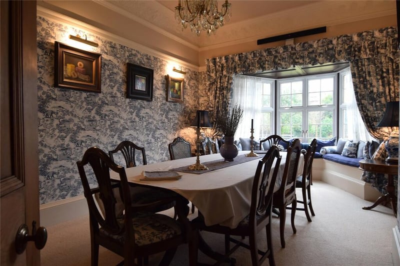 The dining room is a charming room with a south-facing bay window. 