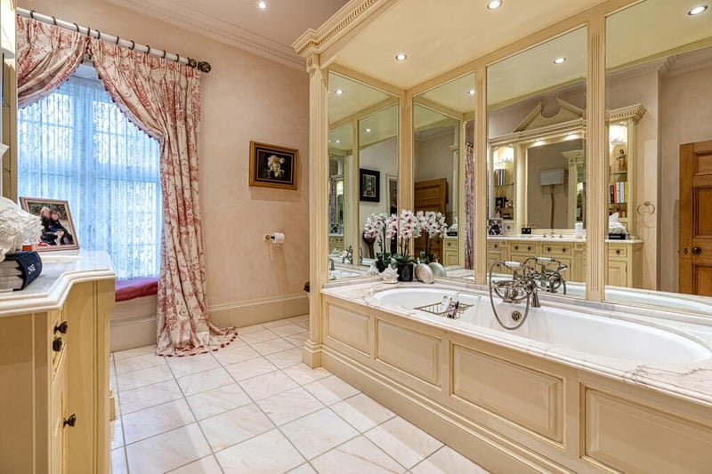 The main family bathroom is designed by Clive Christian and has gorgeous marble tops around the vanity unit and bath as well as a marble tiled floor.