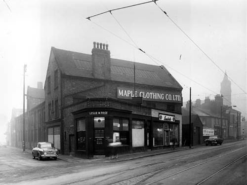 This photo from November 1958 shows a car reg: TYG 50 parked at the end of Admiral Street. On the right at number 129a Dewsbury Road is Leslie M. Page, Opthalmic Optician with the opening times advertised on the door. At number 131 is a laundrette is the Maple Clothing Co. Ltd blouse factory. At the end of the road is the Junction Hotel and visible in the distance is the spire of St Peter's Church.