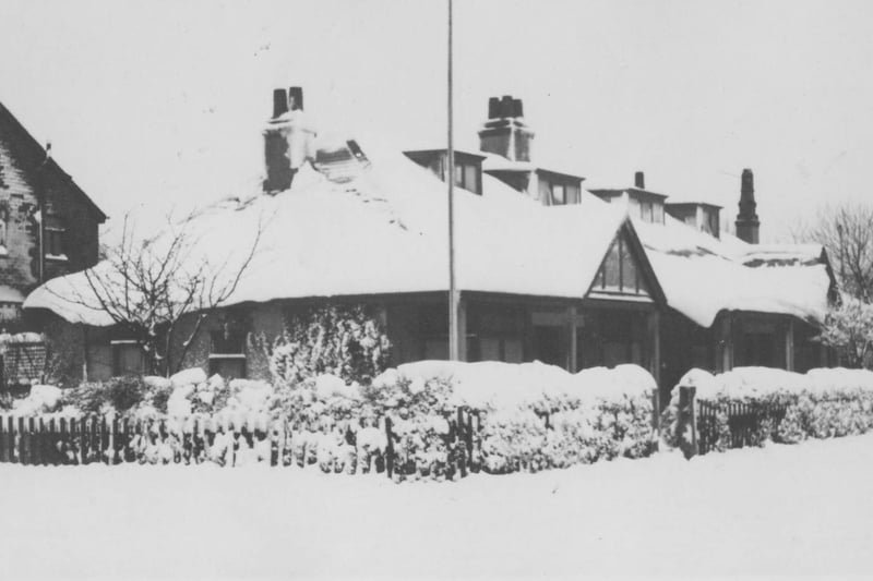 This snowy scene depicts houses in Welbeck Avenue leading up to the entrance to the Memorial Park