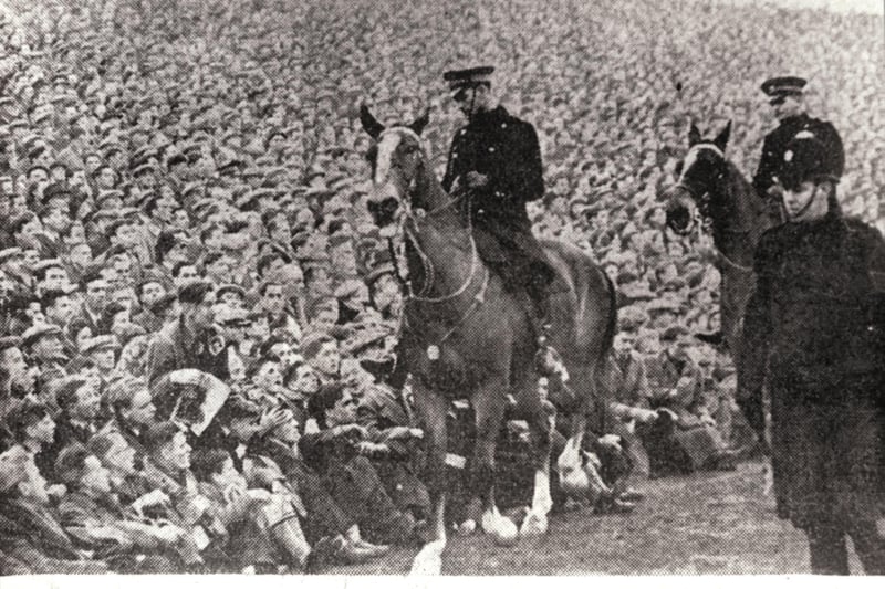 Mounted police keep an eye on the crowds at Easter Road after a "break in"  - the gates had been closed 15 minutes before the start - at an Edinburgh derby Hibs v Hearts football match in January 1950. A record attendance of more than 65,000 fans saw Hearts win the match 1-2.