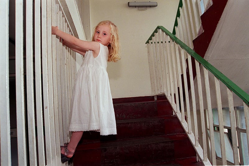  Four year old Laurel Strutt plays on the staircase near her flat on the rundown Norfolk Park Estate August 1998