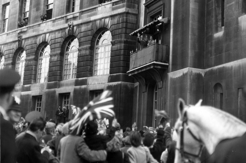 HM Queen Elizabeth II and HRH The Duke of Edinburgh wave to crowds gathered below on Calverley Street from a balcony of Leeds Civic Hall in October 1958.