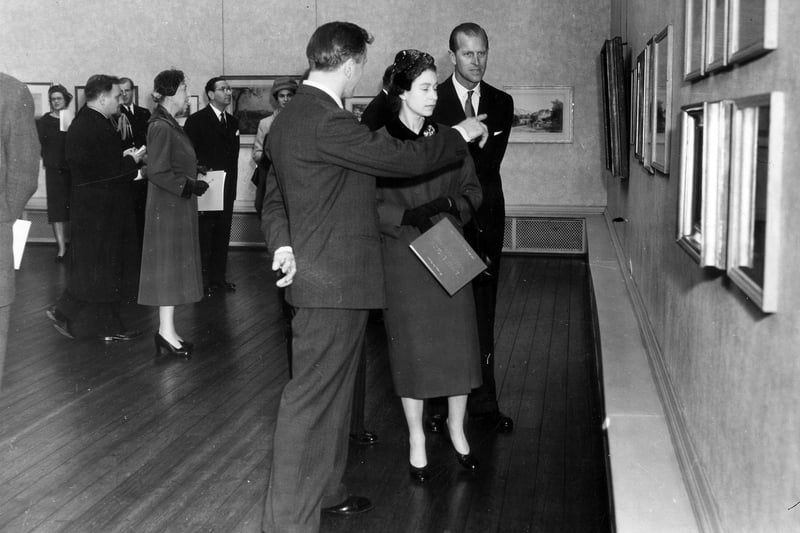 HM Queen Elizabeth II and HRH The Duke of Edinburgh being escorted around Leeds City Art Gallery by Mr R. S. Rowe, the director. The Queen and the Duke were on a two-day visit to Leeds in which they attended events celebrating the centenary of Leeds Triennial Musical Festival.