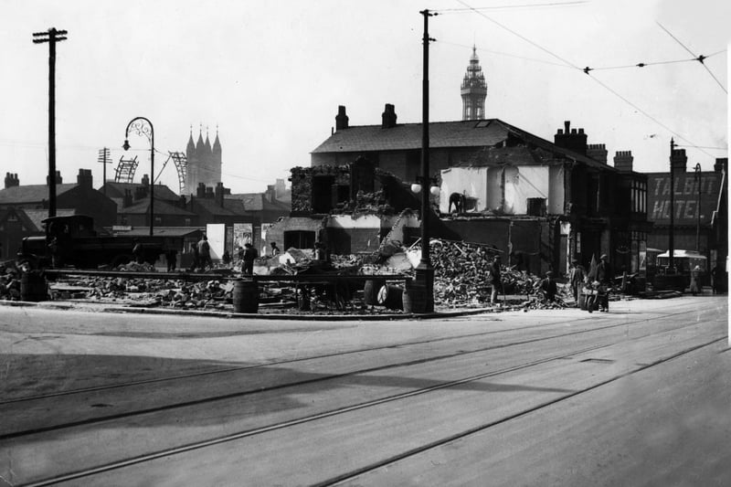 Demolishing property in Talbot Road in 1929 to make way for a bigger Corporation bus station. The partly dismantled big wheel is in the background. Also in the pic are St John's Church and the Talbot Hotel (right)