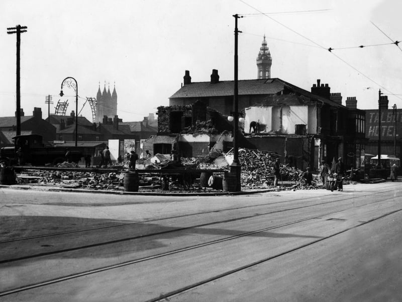 Demolishing property in Talbot Road in 1929 to make way for a bigger Corporation bus station. The partly dismantled big wheel is in the background. Also in the pic are St John's Church and the Talbot Hotel (right)