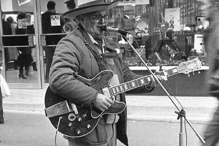 A busker pictured on the streets of Glasgow back in the day. 