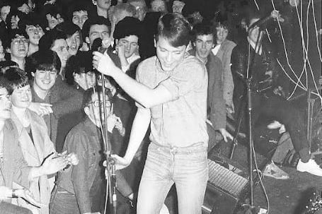 New Order performing live on stage at the Plaza Ballroom in Glasgow which was once the Southside's top dancing spot found at Eglinton Toll/St Andrew's Cross. This was the location of one of New Order's first live gigs. 