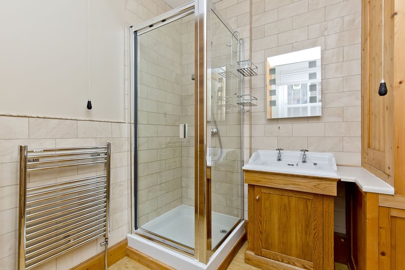 Conveniently, there is a downstairs WC (just off the vestibule) and a separate three-piece shower room, finished with attractive tile work and neutral decor. 