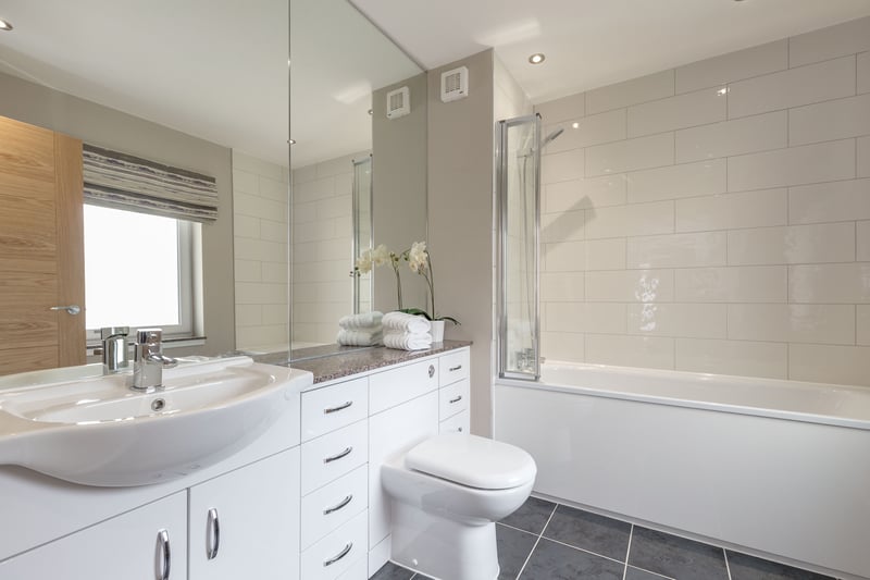 The property's main bathroom is of good size, and like all three bathrooms it has underfloor heating.