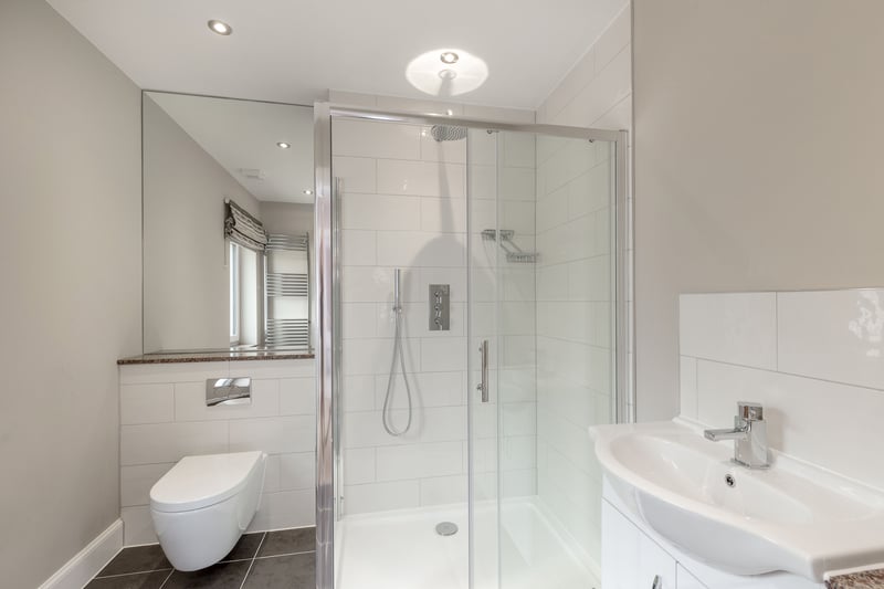 The principal bedroom benefits from this luxury modern shower room en-suite.