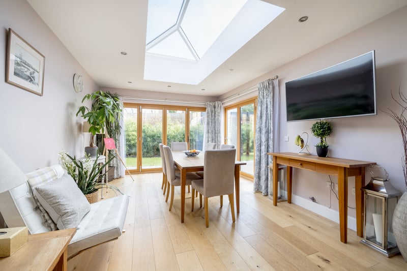 Spanning the rear of the house is the large kitchen/dining /family room with designer cupola, two sets of bi-fold doors to the sunny garden.