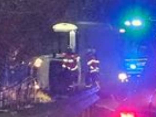 Picture shows a car on its side as firefighters attend the crash on Gleadless Road, Sheffield. Picture: Cameron Lane