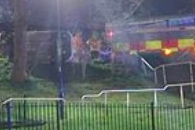 Firefighters at the scene of the crash, seen from the bottom of the grassy bank. Picture: Cameron Lane