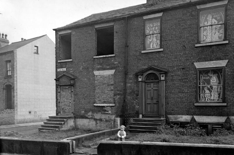 A young child is pictured inn front of a house on Carr Road near Carlton Barracks in October 1951.