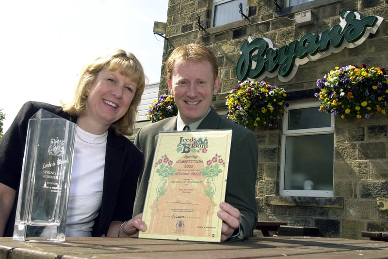 Sue Bray from Bryan's collects the Leeds in Bloom runners-up award from Richard Gill, Leeds Floral Initiatives officer at Leeds City Council in May 2002.