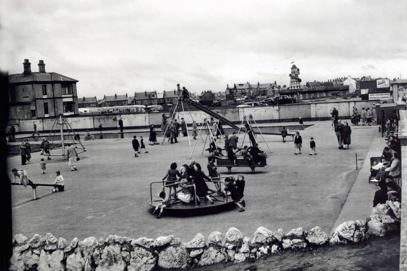 No sign of a multi-screen cinema or any of the other modern buildings that you'll find on Cleveleys Promenade. Children making the most of the traditional playground rides of the early 1950s at Jubilee Gardens. 
A see-saw, slide, roundabout and rocking horse are among the simple trappings to be found alongside the paddling pool. In the distance, closer to the town centre, is a fairground Helter Skelter