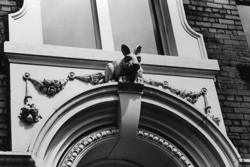 A view of the exterior of one of the doorways of the Cathedral Buildings Dean Street Newcastle upon Tyne taken in 1987. A 'Vampire Rabbit' sits on top of the doorway. Behind the rabbit is a swag of fruit and flowers. Cathedral Buildings were designed by Oliver Leeson