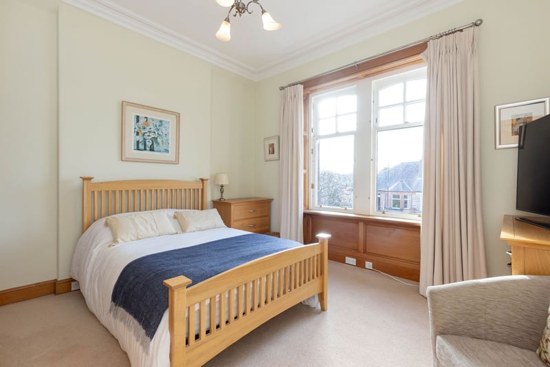 Master bedroom, with windows to front with open views of Arthurs Seat. The room also features some impressive cornice work.