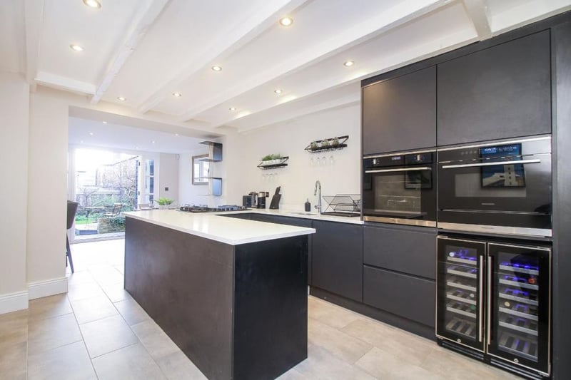 The property's modern kitchen features a number of integrated appliances, including a double oven and a drinks cooler.