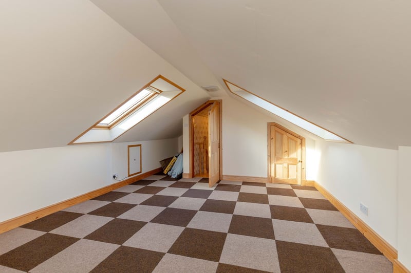 The large attic room with access to eaves storage. The room benefits from velux windows to the front and rear flooding the room with natural light.