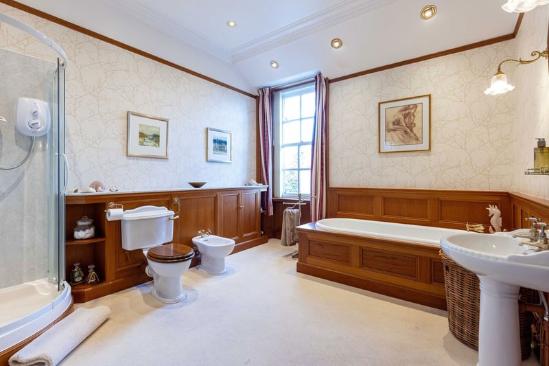 The impressive family bathroom, with white four-piece suite comprising bath,
wash hand basin, bidet and WC. As well as a shower compartment with electric
shower and window to the rear.