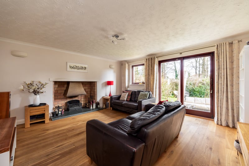 The light and airy reception room with fireplace and door accessing the rear garden.