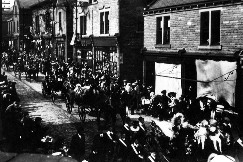 Bramley Carnival parade travelling along Town Street in  May 1907. Participants in horse-drawn carriages include the May Queen and assisants in the front carriage. The first official Bramley Carnival was held in 1892 but it is believed to date back to 1865 unofficially. It was a popular event in the first half of the 20th century but then was not held for many years until being resurrected in 1976.