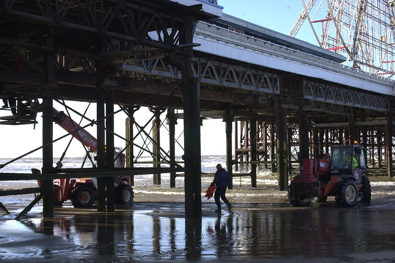 Workmen repair the metalwork of Central Pier in Blackpool despite the high winds