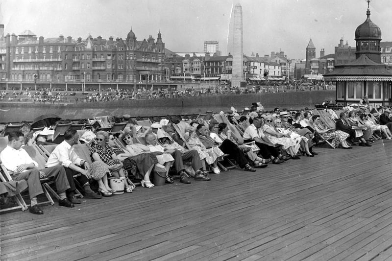 Holidaymakers relaxing  in deckchairs on The North Pier in 1955