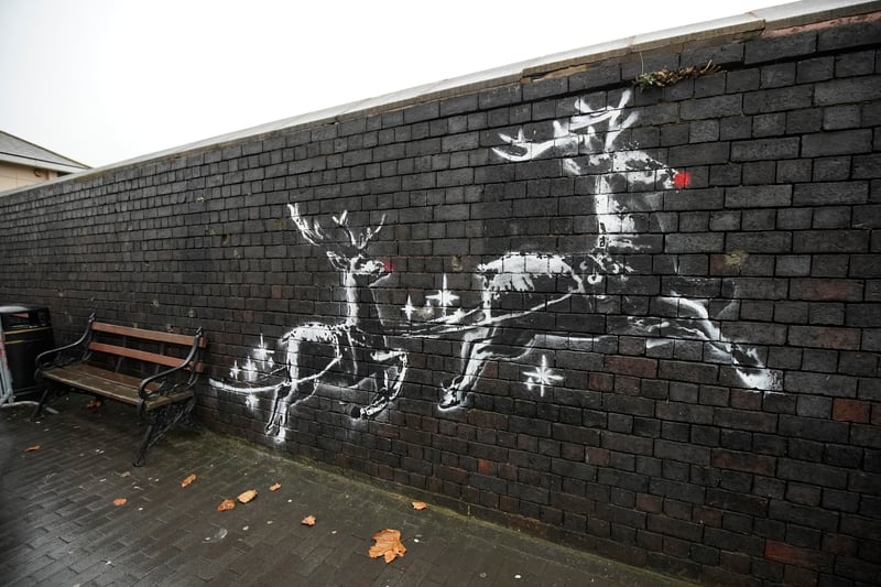 Banksy’s mural, located at Jewellery Quarter and created in December 2019, features two large reindeer pulling a bench behind them.
