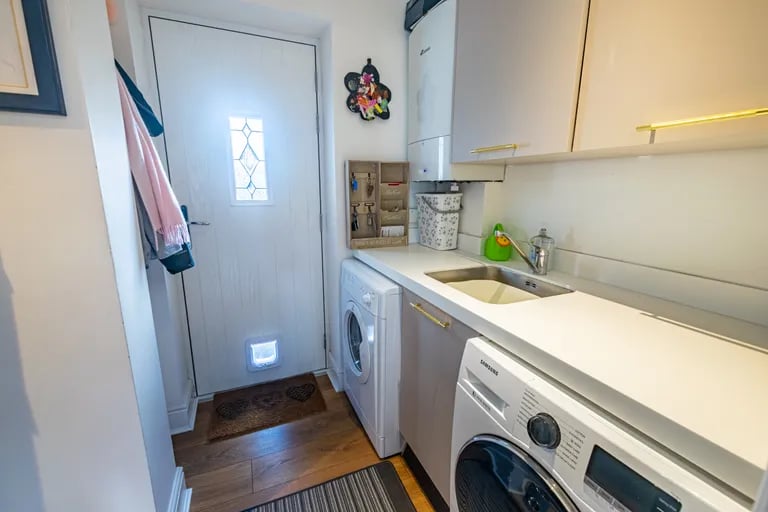 On the ground floor is also a handy utility room with door to the garden.