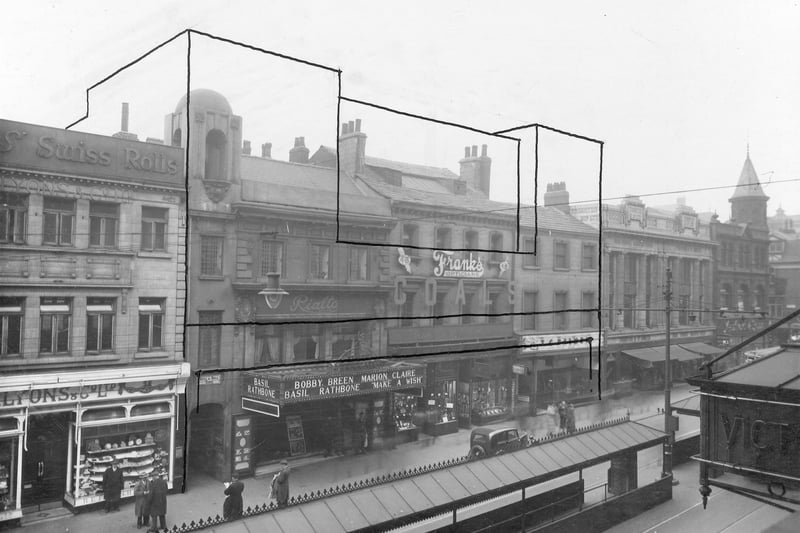 Shops on Briggate in March 1938. The outline around central block of buildings is  where Marks and Spencers was to be built. Pictured, from left, is Lyons and Co, Bull and Bell Yard and Rialto Cinema.