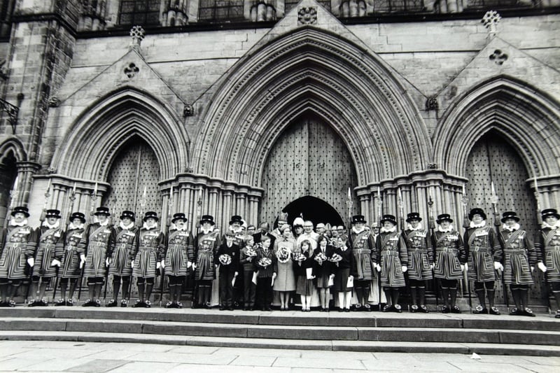 The Yeoman of the Guard line up behind the Queen, local schoolchildren and dignitaries on the steps of Ripon Cathedral in April 1985.