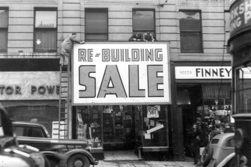 Stone's Radio shop on Briggate with signs being put up which state 'Re-building sale'. Pictured in January 1939.