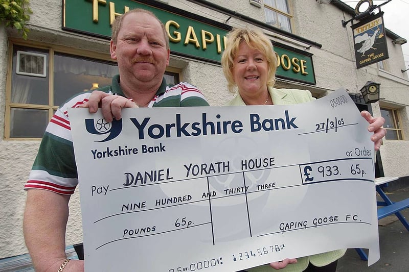 Landlord Trevor Foster hands a fund raising cheque over to Ann Buckler, Unit General Manager of Daniel Yorath House in June 2005.
