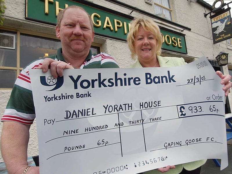 Landlord of The Gaping Goose, Trevor Foster, hands a fund raising cheque over to Ann Buckler, Unit General Manager of Daniel Yorath House in June 2005.