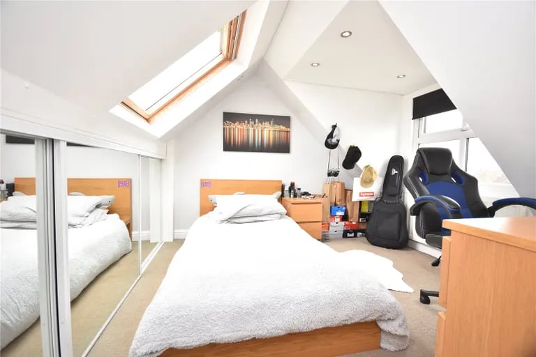 Two additional bedrooms with skylight windows can be found on the second floor.