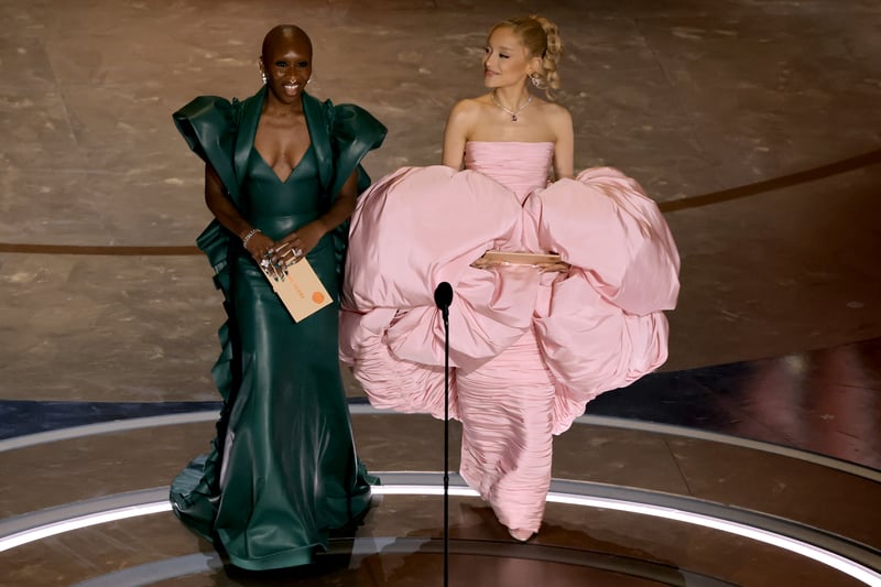 Cynthia Erivo and Ariana Grande speak onstage during the 96th Annual Academy Awards, with their dresses reflecting their roles in the upcoming Wicked movie. 