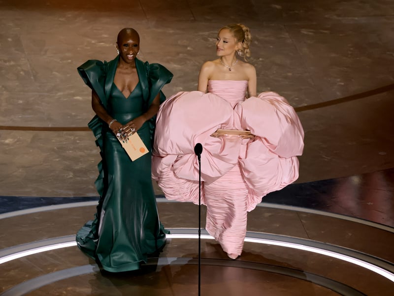Cynthia Erivo and Ariana Grande speak onstage during the 96th Annual Academy Awards, with their dresses reflecting their roles in the upcoming Wicked movie.
