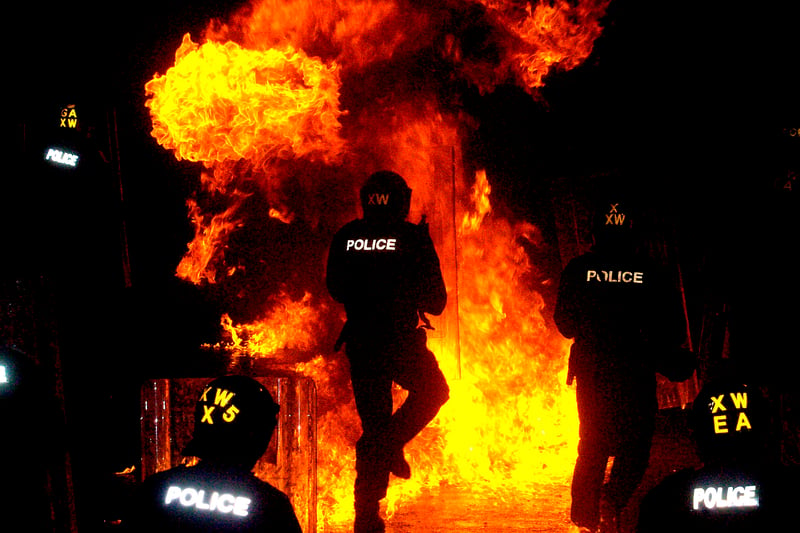 West Yorkshire & North Yorkshire Police took part in a public order training course on the Howley Park, Industrial Estate in Oxtober 2007. Pictured are riot police officers running through fire after petrol bombs were thrown by rioters during the exercise.