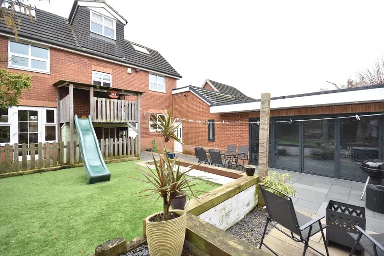 The rear garden is a real show-stopper with artificial lawn and a purpose built play area.