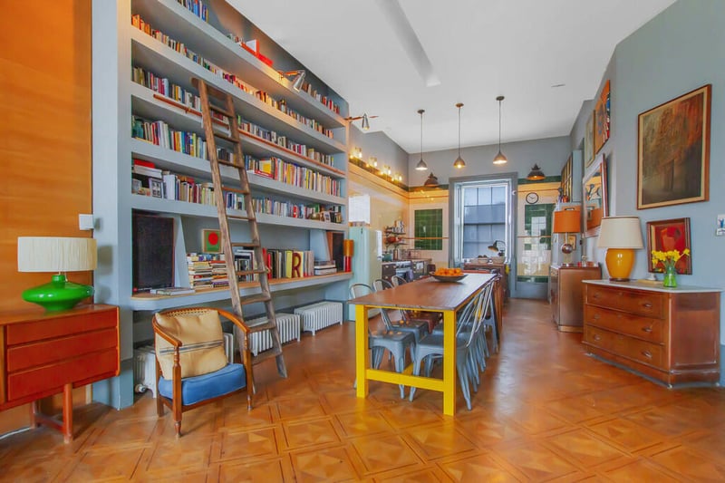 A look at the bright 40ft open plan kitchen and dining space with a terrific bookcase. 