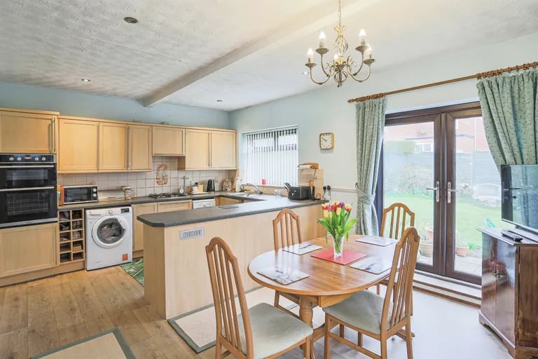 Here is wooden flooring and double French doors leading to the rear garden.