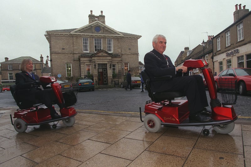 The Mayor and Mayoress of Wetherby, Coun Gerald and Rita Wilkinson, take to the streets in front of the Town Hall on new shopmobility scooters which were  available for hire at the town's One Stop Centre. Pictured in November 1999.