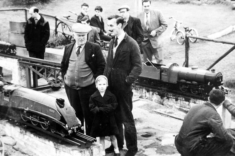 People enjoying the model locomotives at Blackgates Miniature Railway. In the foreground there is a model of an A4 Streamline Locomotive. This type of locomotive was designed by Sir Nigel Gresley for the London and North Eastern railway in 1935.