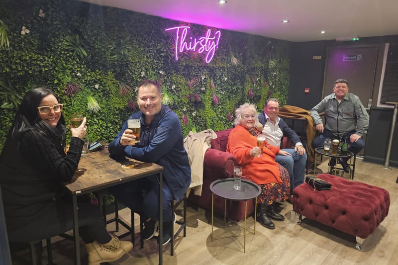 Customers toast the re-launch of the Thirsty?Alehouse in the back lounge