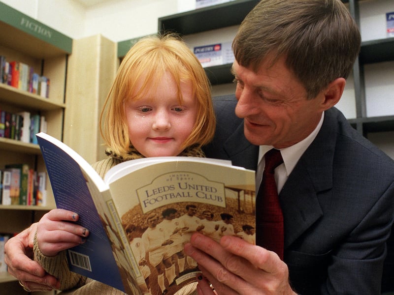 Former striker Allan Clarke reads from a new Leeds United book with young Bethany Patrick at Philip Howard Books on Street Lane in November 1999.