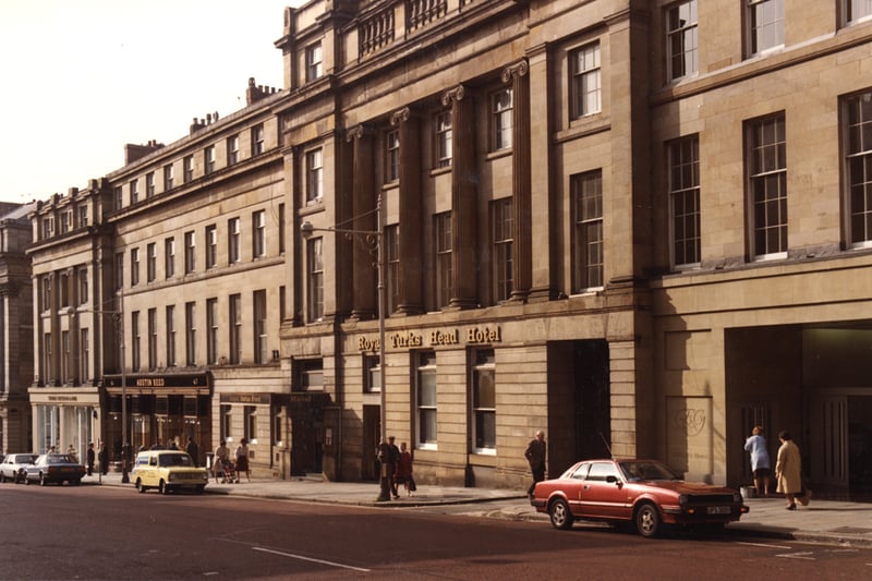  A 1983 photograph of the Royal Turks Head Hotel on Grey Street. The photgraph has been taken from the Theatre Royal looking down Grey Street. The Royal Turks Hotel is in the foreground. Austin Reed adjoins the hotel to the left with other shops and offices beyond.